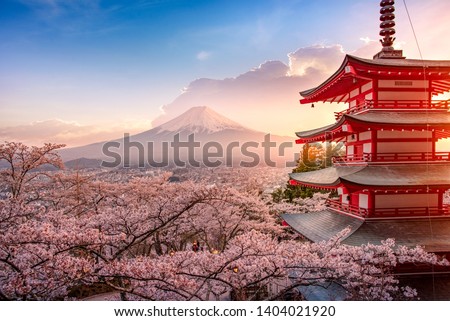 Fujiyoshida, Japan Beautiful view of mountain Fuji and Chureito pagoda at sunset, japan in the spring with cherry blossoms Royalty-Free Stock Photo #1404021920