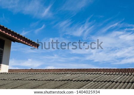 black tile roof on a old house with clear blue sky background.copy space for texture background.