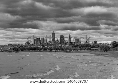Rough waters and dramatic clouds over the cleveland skyline at edgewater park. 
