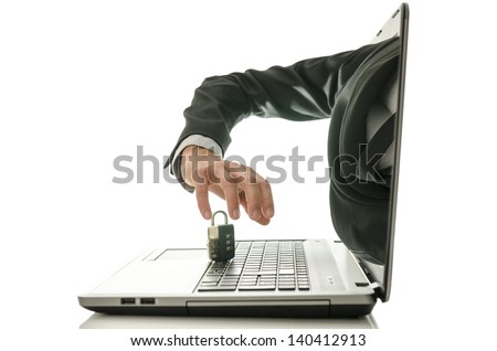 Hacker stealing padlock through a laptop monitor. Concept of computer crime.