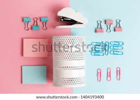 A office stationery on pink and blue background, top view, back to school concept