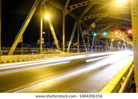 motion blurred traffic on bridge, dusk urban night traffic on the highway skyline.