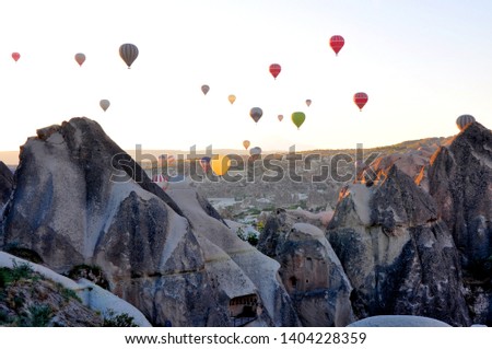  Colorful hot air balloons flying over the valley at Cappadocia. Hot air balloons are traditional touristic attraction in Cappadocia. Royalty-Free Stock Photo #1404228359