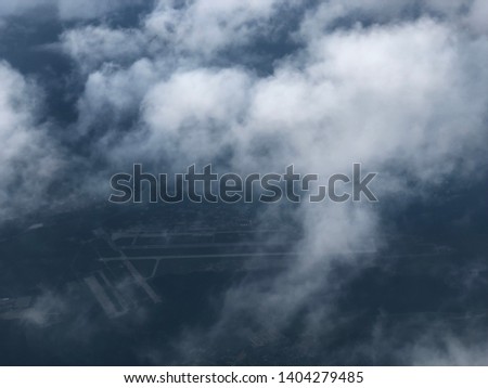 Sky scape or cloudscape from aerial airplane shot of blue and white fluffy clouds. View or a photo shot taking from aircraft windows. over a moscow, russia