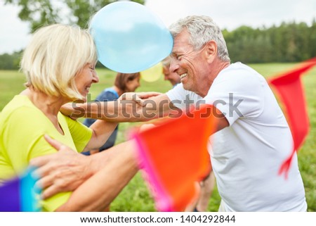 Seniors at a party play balloons to get to know each other