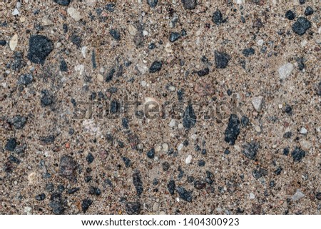 Asphalt segment with a characteristic texture of small stones and sand