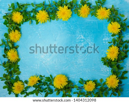 Frame of young green twigs with dandelions. Great background for design.