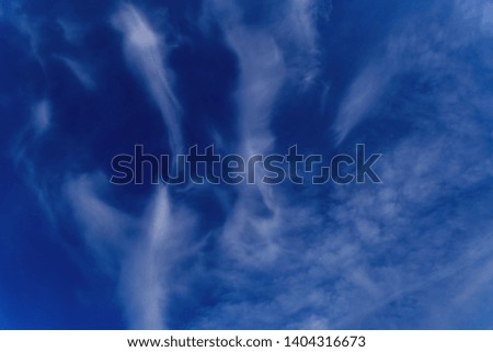 Beautiful blue sky with white cirrus clouds as a natural background