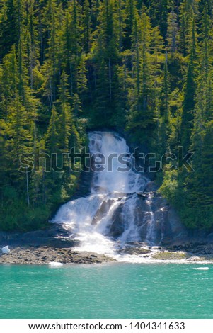 Waterfall cascading down a mountainside in Alaska.