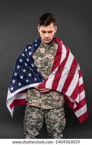 upset man in military uniform with american flag isolated on grey 