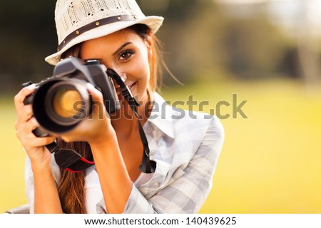 attractive young woman talking pictures outdoors Royalty-Free Stock Photo #140439625