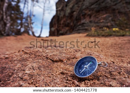compass on the background of rocks, a symbol of travel and adventure