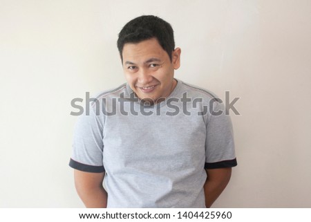 Photo image portrait of funny young attractive cute Asian man smiling happily