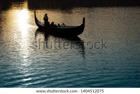 Gondola boats on the lake at sunset