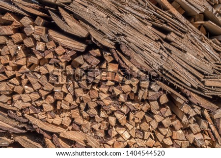 Firewood cut and stacked neatly in pile outside ready for use in fireplaces and wood burners