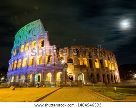 A night time picture of Oval amphitheatre in the centre of the city of Rome, Italy with light and full moon with no people