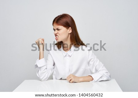 Emotional woman sitting at a desk office white shirt finance job