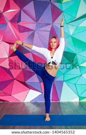 Young sporty girl doing stretching foot vertical picture