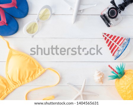 top view travel concept with bikini, map, passport, action camera and travel accessories on white wooden background, Tourist essentials, vintage tone effect