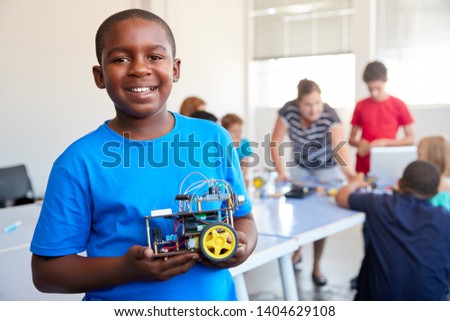 Portrait Of Male Student Building Robot Vehicle In After School Computer Coding Class Royalty-Free Stock Photo #1404629108