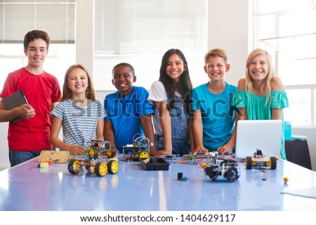 Portrait Of Male And Female Students Building Robot Vehicle In After School Computer Coding Class Royalty-Free Stock Photo #1404629117