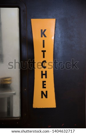 Kitchen name board on door at a restaurant. Kitchen Door - Image
