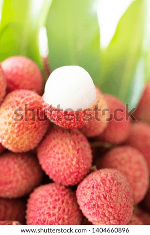 Tropical fruits in Thailand : Fresh lychee and peeled showing the red skin and white flesh with green leaf on white background.Lychee in Thailand Export around the world.