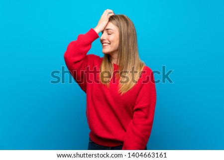 Woman with red sweater over blue wall has realized something and intending the solution