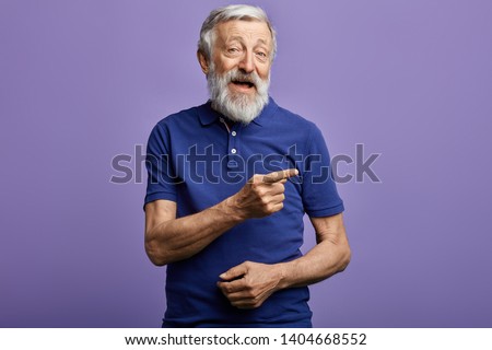 positive man pointing with hand and finger to the side. look here, happy old man showing direction, pension is being given here. this is the right way.