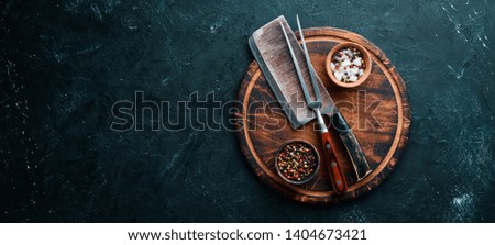 The old kitchen knife and Wooden boards on a black background. Top view. Free space for your text.