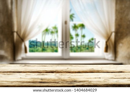 Table background of free space for your decoration and summer window. Landscape of natural palms. 