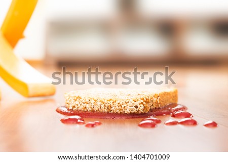 Concept representation of Murphy’s law with a slice of bread fallen upside down