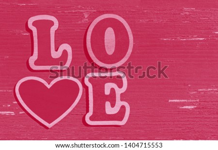 pink Valentines Day background: word love made of wooden letters
