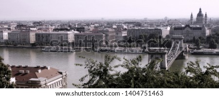 Vibrant view of hanging bringe over large Danube river in summer Budapest under blue sky