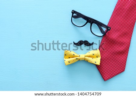 Father's day concept. Necktie and mustache over wooden background. top view, flat lay