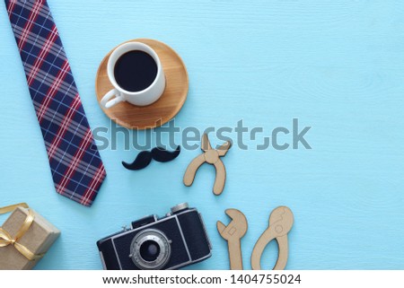 Father's day concept. gift box, tie and funny moustache over wooden background. top view, flat lay