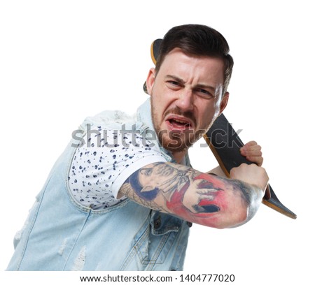 An angry tattooed man attacks. The guy swung to hit the skateboard. Isolated on white background. A collection of emotional people. The guy in the denim vest swung his skateboard.