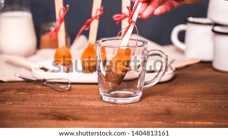 Salted caramel hot cocoa spoons in glass cup.
