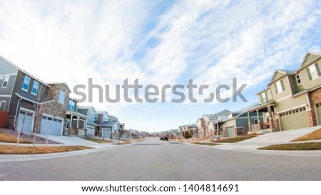 Driving through new residential neighborhood in suburbia. Royalty-Free Stock Photo #1404814691