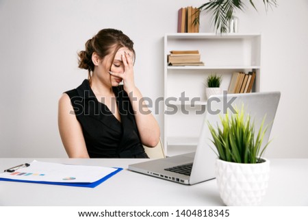 Frustrated female worker in office ather desk. Sick and tired woman.