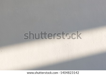 simplicity empty white cement wall with line of sun light and shadow at afternoon. used for template, background or texture. Royalty-Free Stock Photo #1404823142