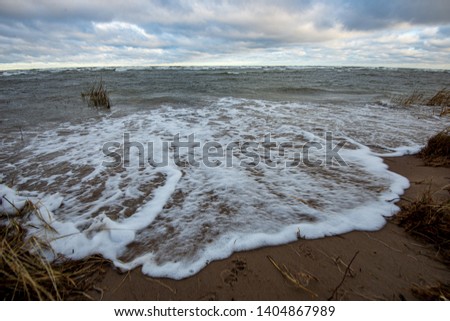 lake or sea sand beach in stormy weather in summer