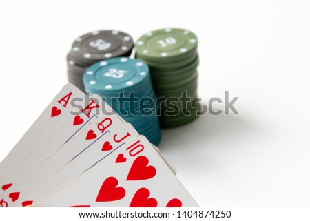 Cards, flash royal, casino chips close-up on a white background.