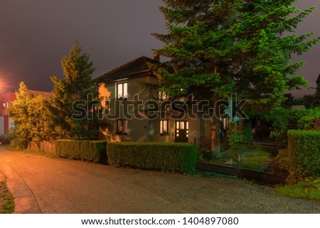 Small house in the countryside with a beautiful garden at night Royalty-Free Stock Photo #1404897080