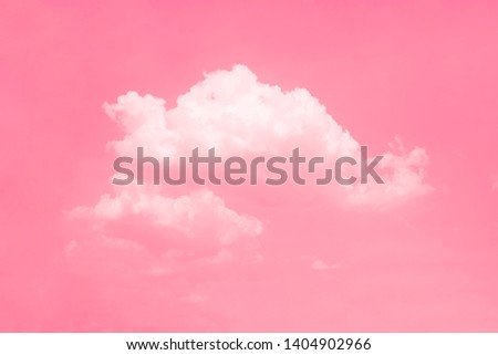 Pink sky background with white clouds.