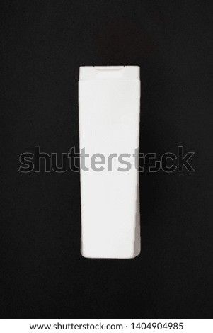 Plastic cosmetic bottle on a black background
