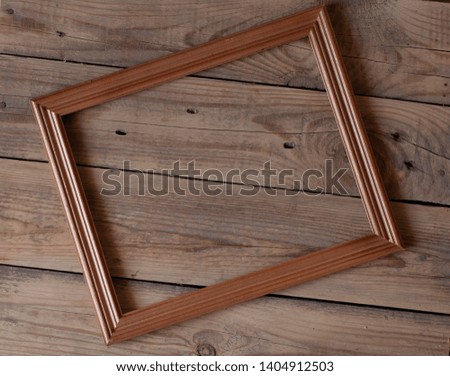 empty picture wooden frame on a wooden table top view