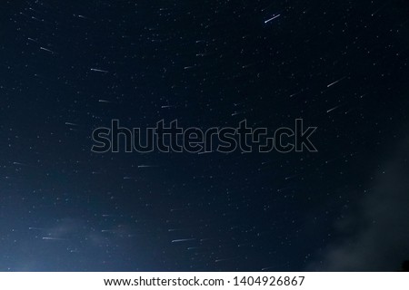 Long exposure photo of stars in the night sky. The earth rotates for closer stars in a 30 second exposure, and stays still for farther ones. Jupiter being the closest to us, creates a bolder trail.