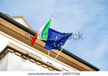 Low angle view of The European flag of Europe and Italian flag waving in wind official delegation embassy consulate