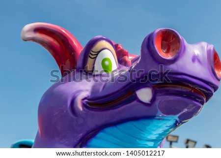 Purple Dragon Statue head only with a blue sky in the background 